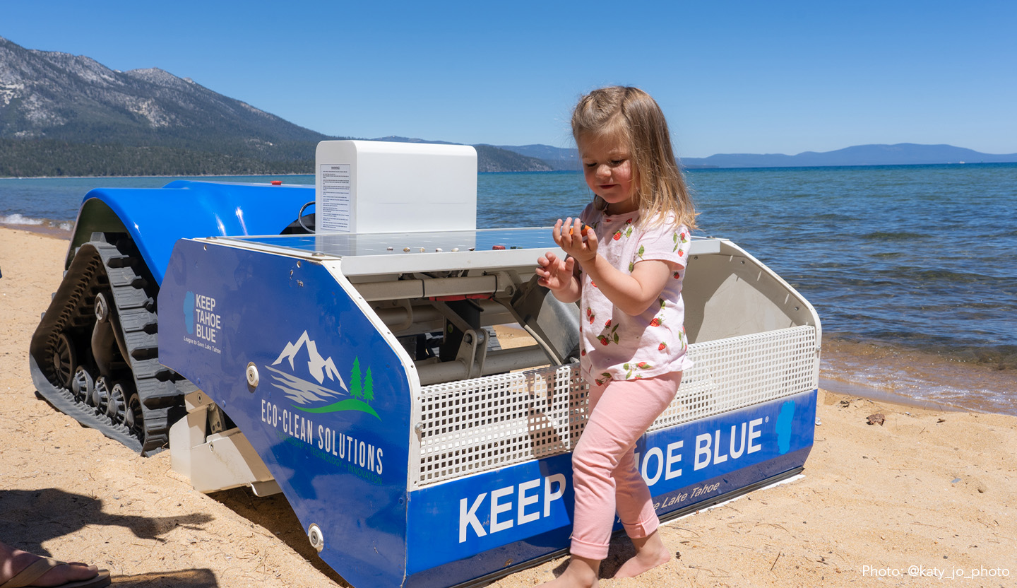 A child and robot on the beach at Tahoe.