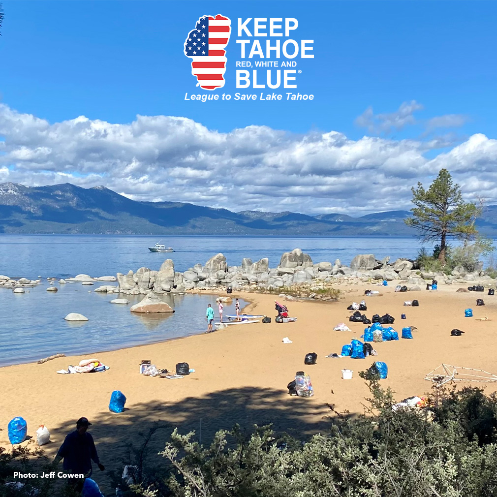 Bags of litter sit on the sand of a Tahoe beach after July 4th.