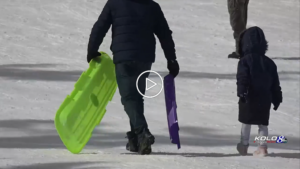 A father and child sledding