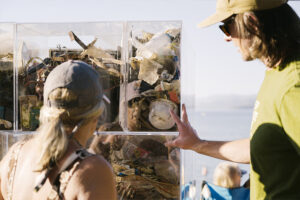 Examining the trash cube exhibit