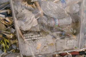 Trash cube - close-up on plastic bottle message